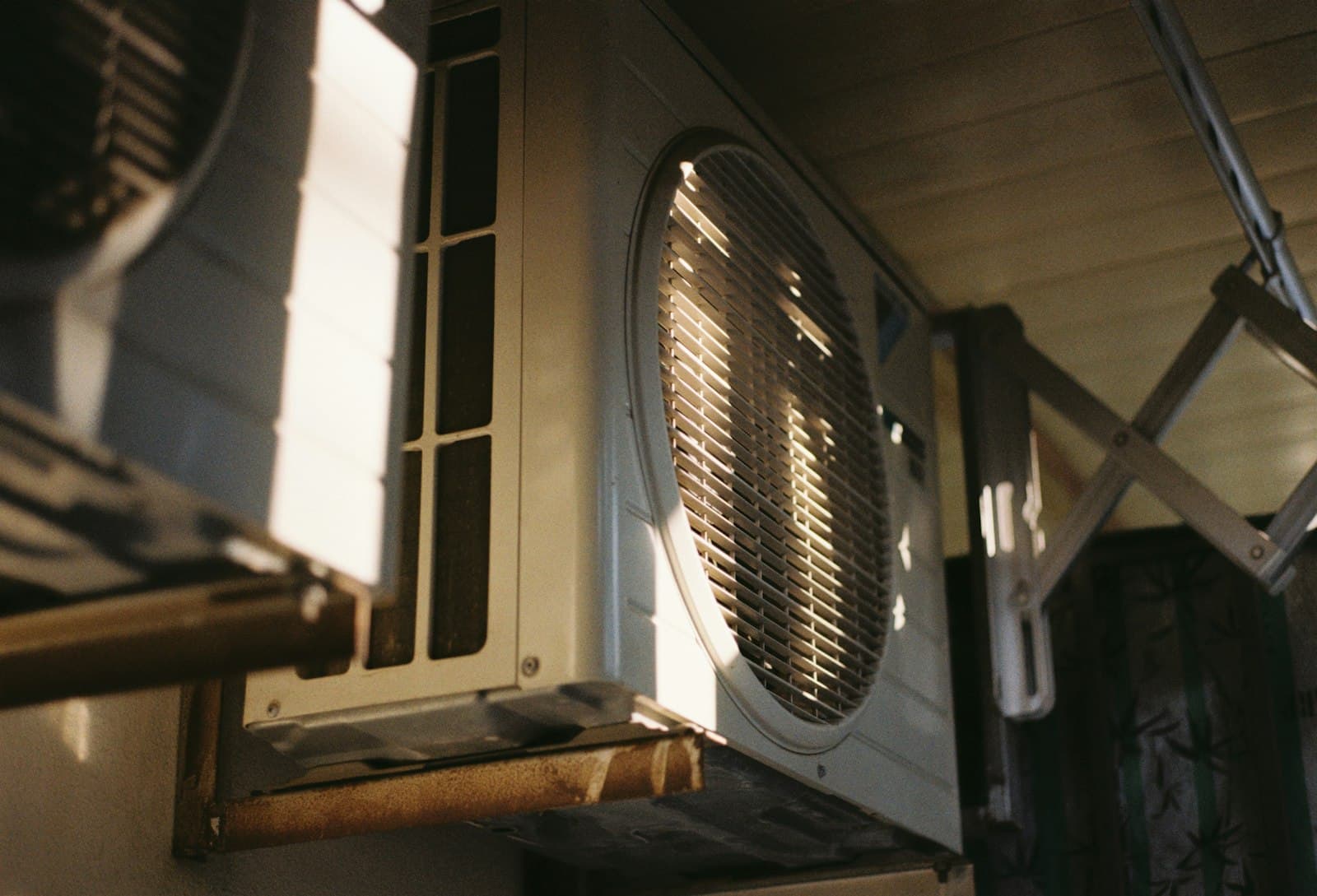 Outdoor air conditioning condenser on a residential wall