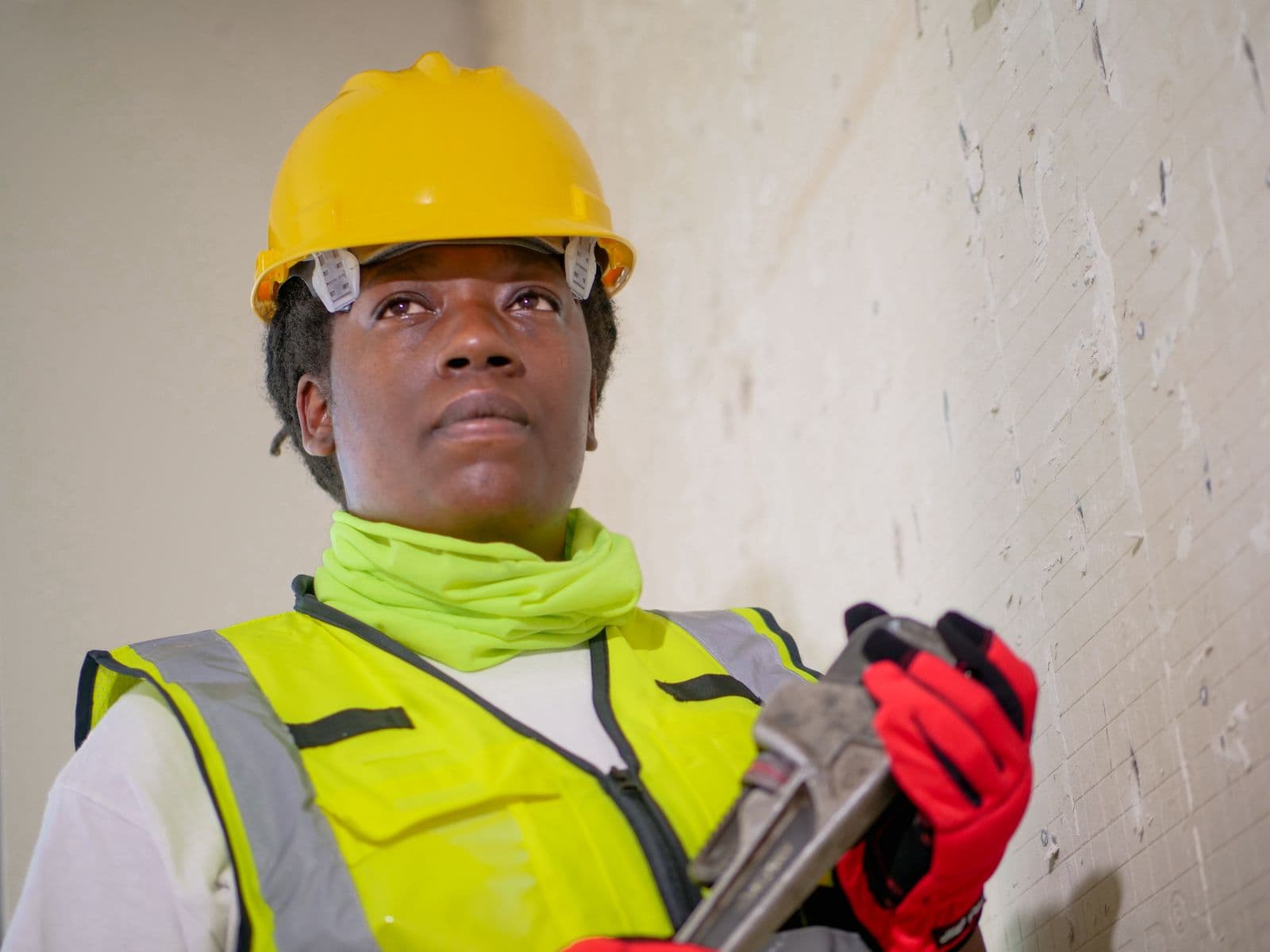 HVAC technician on a job with a pipe wrench